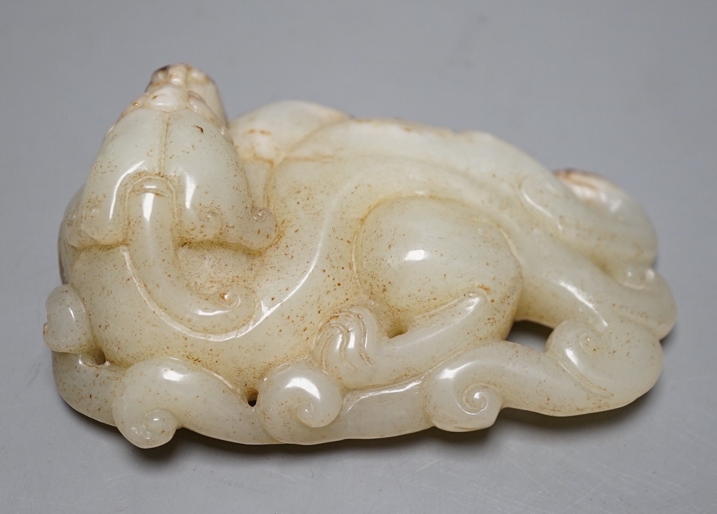 A Chinese pale celadon jade chilong carving, 10cm